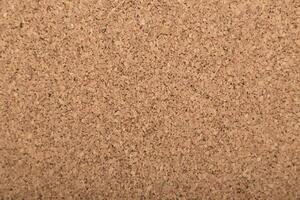 Close-up view of textured cork surface highlighting natural fibers and grains in soft lighting photo