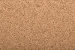 Background of cork board in light tan color used for various display purposes in homes or offices photo