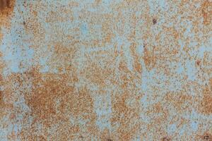 Rusty blue surface showing texture and decay, highlighting years of exposure and wear in an industrial setting photo