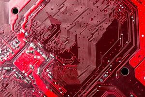 Close up of a printed red computer circuit board photo