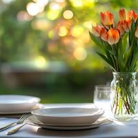A table setting with a vase of tulips photo