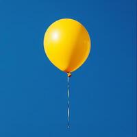 A yellow balloon floating in the blue sky photo