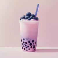A bubble tea with blueberries and a straw photo