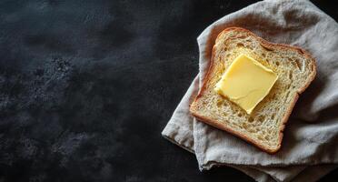 Butter on bread on a black background photo