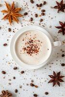 Cocoa latte with cinnamon and star anise on white background photo