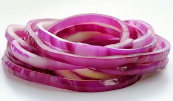 A bunch of red onion slices on a white surface photo