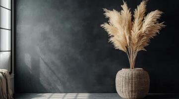 A vase with pampas grass in front of a window photo