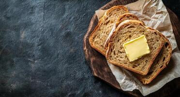Butter on bread on a wooden board photo