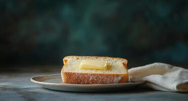 A slice of bread with butter on a plate photo