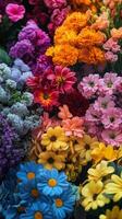 A large variety of colorful flowers are arranged in a vase photo