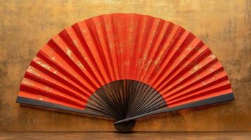 A red fan is sitting on a table photo