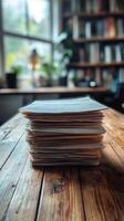 A stack of papers on a wooden table photo