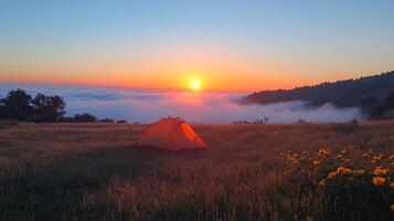 Tent in the mountains at sunrise photo