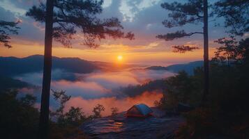 A tent is set up on a cliff overlooking the clouds photo