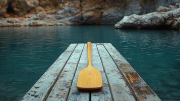 A wooden paddle on a dock photo