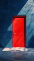 A red door is open in a room with a blue wall photo