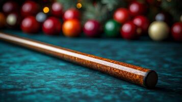 A billiard stick on a table with christmas balls photo