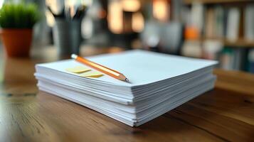 A stack of papers with a pencil on top photo