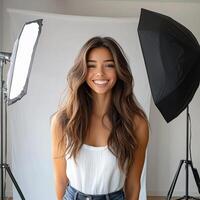 A woman smiling in front of a white backdrop photo