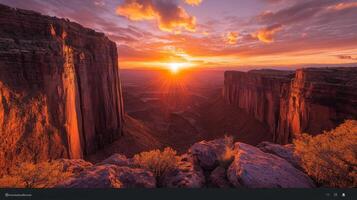 The sun sets over a canyon in the arizona desert photo