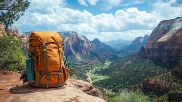 A backpack sits on top of a rock overlooking a valley photo