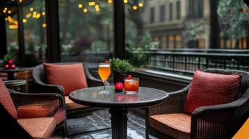A patio table with two chairs and a glass of wine photo