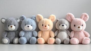 Five teddy bears in different colors are lined up photo