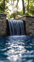 A waterfall flowing into a pool in the backyard photo