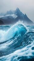 A wave breaking on the ocean with mountains in the background photo