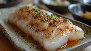 A plate of food with a piece of fish on it photo