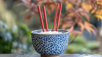 A bowl with chopsticks in it photo