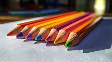A group of colored pencils sitting on top of a piece of paper photo