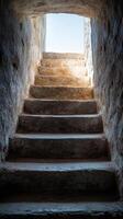 A stone stairway leads to a light at the top photo