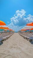 A row of beach chairs and umbrellas on a sandy beach photo