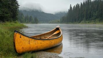 A canoe on the shore of a river photo