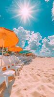 A row of white chairs and orange umbrellas on a beach photo