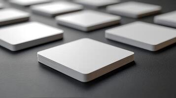 White square cards on a black surface photo