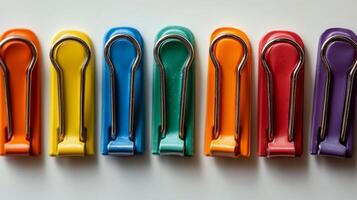 A row of colorful plastic clips photo