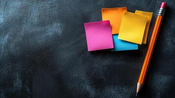 A pencil and several sticky notes on a blackboard photo