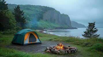 A tent set up on a beach with a fire pit photo