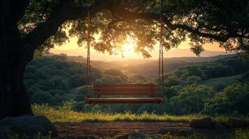 A swing sitting under a tree at sunset photo