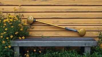 A wooden bench with a garden tool on it photo