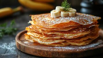 A stack of pancakes with bananas on top photo