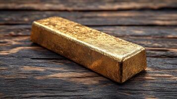 Gold bar on wooden table photo