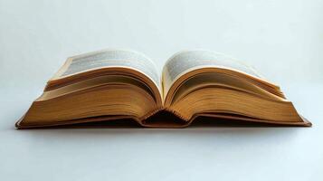 An open book on a white surface photo