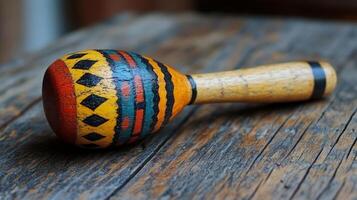A wooden maraca with colorful designs on it photo