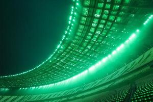A green light shines on the ceiling of a stadium photo