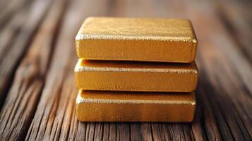 Gold bars on wooden table photo