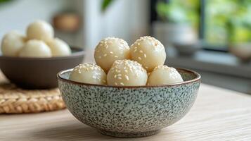 A bowl filled with white rice balls photo
