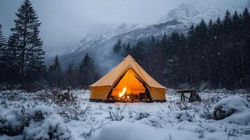 A tent is set up in the snow with a fire photo